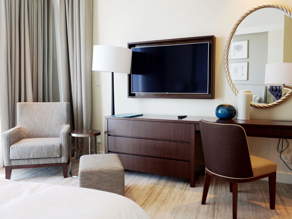 Hospitality IPTV Systems 1 Hotel room with a wall-mounted television, illustrating the guest viewing environment